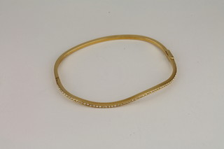 A gilt metal bracelet set white stones