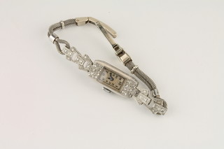 A lady's Art Deco platinum cocktail wristwatch on a 9ct gold bracelet set diamonds
