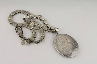 A silver flat link necklet together with an engraved silver locket