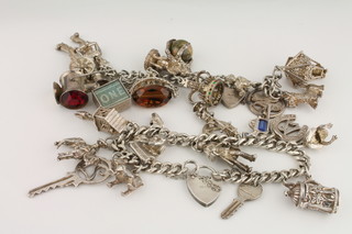2 silver curb link charm bracelets hung numerous charms