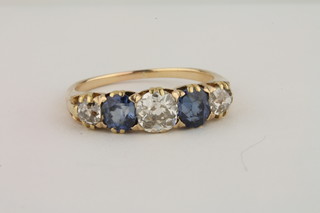 A gold dress ring set 3 diamonds and 2 sapphires
