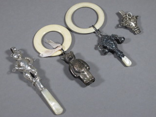 2 silver rattles in the form of bears and 2 other rattles