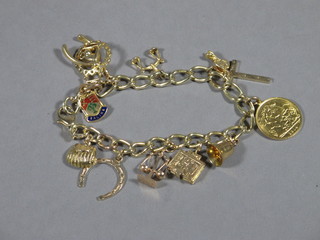 A gold curb link charm bracelet hung numerous charms