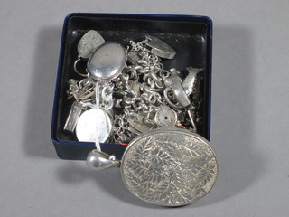 2 silver charm bracelets hung numerous charms, an oval  engraved silver lockets, 2 silver lockets and a brooch