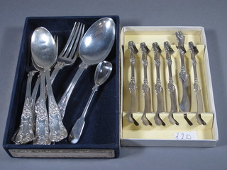 6 Sterling butter knives, cased, 2 table spoons, 2 table forks, 2 pudding forks and a silver plated mustard spoon, contained in a  silver mounted box
