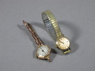 A lady's octagonal shaped wristwatch contained in a gold case and a lady's Eterna.matic wristwatch in a gold case