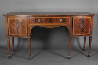 An inlaid mahogany bow front sideboard fitted a drawer flanked  by a pair of cupboards, raised on square tapering supports ending  in spade feet 72"