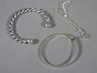 A silver curb link bracelet and 2 silver bangles