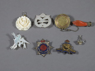 An Army Air Corps sweetheart brooch, an enamelled Royal Artillery sweetheart brooch, do. Army Service Corps, do.  Parachute Regt. a carved ivory pendant in the form of a rose,  circular pinch beck brooch and a coral brooch in the form of a  hand