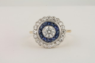 An 18ct yellow gold dress ring set a row of diamonds, a row of sapphires and a diamond