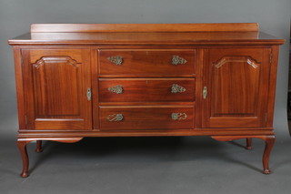 A mahogany sideboard with raised back, fitted 3 long drawers  flanked by a pair of cupboards, raised on cabriole supports 72"