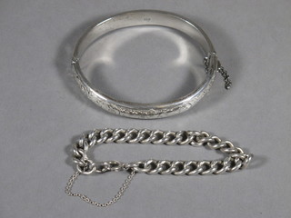 A silver curb link bracelet and a silver bangle