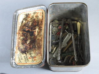 A Grantham's metal tea caddy containing a pair of nut crackers,  pocket knife and other curios