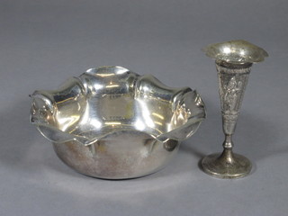 An embossed Eastern white metal trumpet shaped vase 3 1/2" and a circular silver plated dish