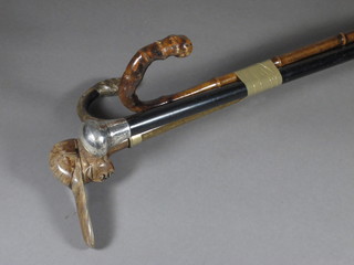 An ebony walking cane with silver knob and 3 other sticks
