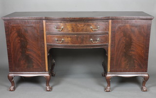 A Georgian style mahogany bow front sideboard fitted 2 drawers flanked by a pair of  cupboards, raised on cabriole ball and claw supports 72"
