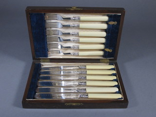 A set of 6 Victorian silver plated fruit knives and forks contained  in a mahogany box