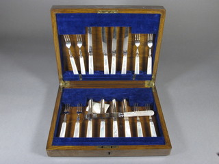 A set of 4 silver plated fruit knives and forks with mother of  pearl handles and a serving knife