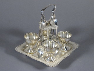 A silver plated 4 piece egg cruet complete with spoons