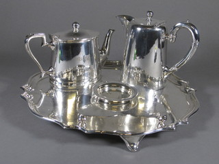 A circular silver plated salver with bracketed border 14", an oval hotelware teapot, a hotwater jug and a cruet stand base