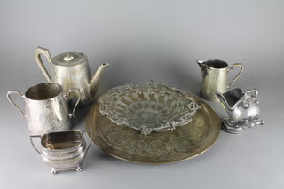 A Victorian engraved silver plated 3 piece tea service by Mappin  & Webb with teapot, twin handled sugar bowl and milk jug, a  silver plated sugar bowl, a Britannia metal sugar scuttle, a  pierced metal cake basket and a brass tray