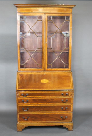 An Edwardian inlaid mahogany bureau bookcase with moulded  cornice, the upper section fitted shelves enclosed by astragal  glazed panelled doors, the base with fall front revealing a well   fitted interior above 4 long drawers, raised on bracket feet 36"