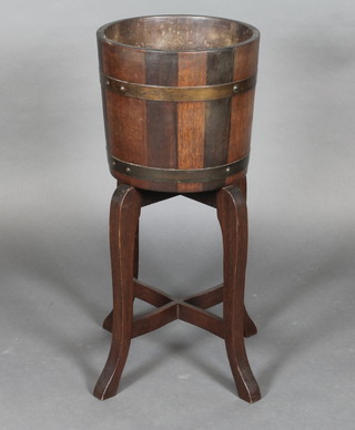 A circular coopered oak jardiniere raised on cabriole supports  12"