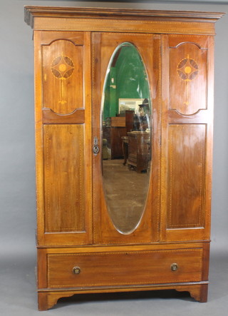 An Edwardian inlaid mahogany wardrobe with moulded cornice enclosed by an arch bevelled plate mirrored door, the base fitted  a drawer, raised on bracket feet 51"