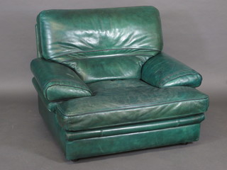 A pair of Herman Miller armchairs upholstered in green leather