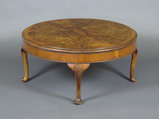 A circular figured walnut coffee table with crossbanded top,  raised on cabriole supports 33"