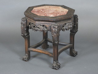 An Eastern octagonal carved and pierced hardwood jardiniere stand with pink veined marble top 17"