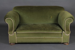 A double drop arm sofa, upholstered in green material 59"