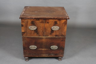 A 19th Century mahogany chest commode raised on bun feet  24"