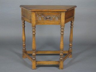 A carved oak Credence table fitted a drawer and raised on turned and block supports 30"
