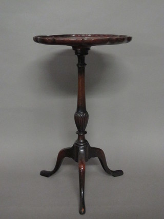 A circular Georgian style wine table with pie crust edge raised on pillar and tripod supports, f and r,