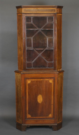 A 19th Century inlaid mahogany double corner cabinet, the upper section with moulded cornice the interior fitted adjustable shelves  enclosed by astragal glazed doors, the base fitted a cupboard  enclosed by panelled doors, raised on bracket feet 32"