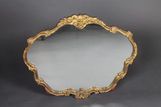 A shaped plate mirror contained in a decorative gilt frame 23"