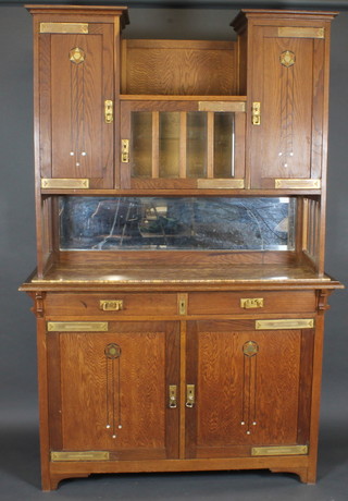 A Continental Art Nouveau inlaid oak sideboard, the raised back  fitted 2 cupboards enclosed by a panelled door, the upper section  fitted a cupboard enclosed by a glazed panelled door flanked by a   pair of cupboards enclosed by panelled doors with recess, the  base fitted a marble top above 2 short drawers with panelled  doors, raised on square supports 54"