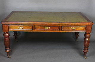 A Maples Victorian mahogany library table with inset green leather  writing surface above 6 long drawers, raised on turned and  reeded supports 72"  ILLUSTRATED