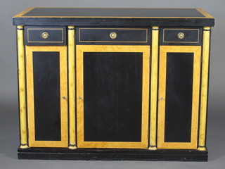 A Biedermeier style ebonised and walnut cabinet fitted 1 long and  2 short drawers above triple cupboards enclosed by panelled  doors, with coral decoration, 47"