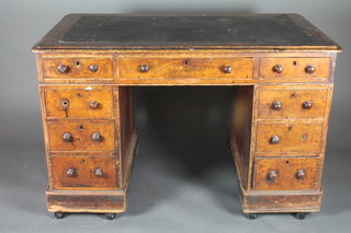 A Victorian mahogany kneehole pedestal desk with inset writing surface above 1 long and 8 short drawers 48"