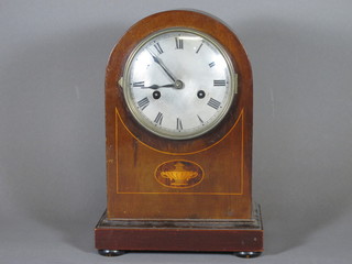 A striking bracket clock with silver dial and Arabic numerals contained in an inlaid mahogany case