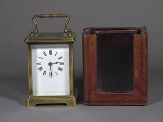 A 19th Century French 8 day carriage clock with enamelled dial  and Roman numerals contained in a gilt metal case 3", complete  with leather travelling case