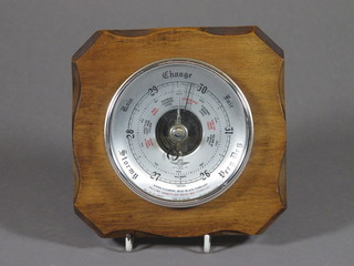 An aneroid barometer with silvered dial by S B contained in an  oak case