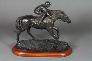 A bronzed figure of a race horse with jockey up 9"