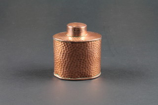 An oval planished copper caddy, the base marked J S & S 3"