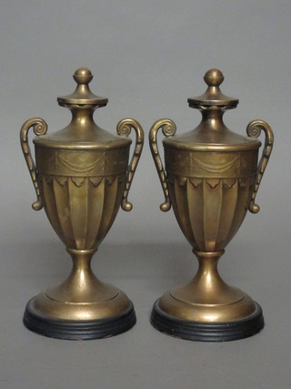 A pair of gilt metal twin handled lidded urns 11"