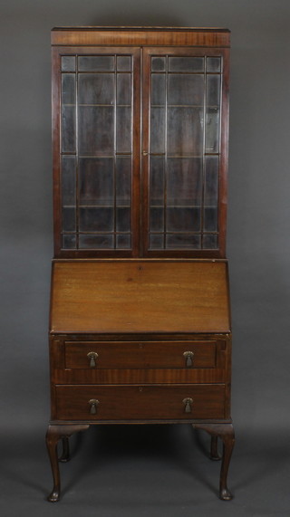 A 1930's mahogany bureau bookcase, fitted adjustable shelves enclosed by astragal glazed doors, the fall front revealing a well  fitted interior above 2 long drawers, raised on cabriole supports