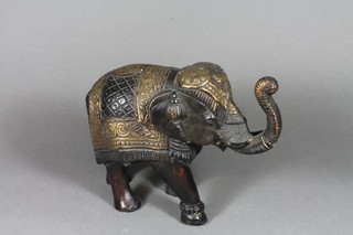 An Eastern bronze figure of a walking elephant 8"