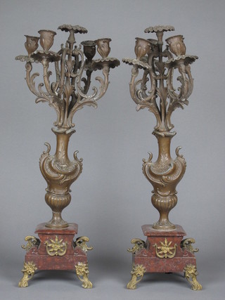 An impressive pair of 5 light spelter candelabrum raised on marble bases  ILLUSTRATED